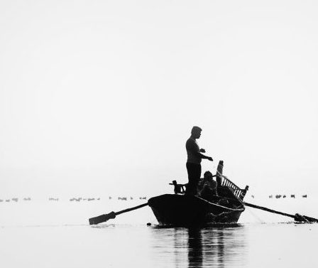 a man in a traditional boat