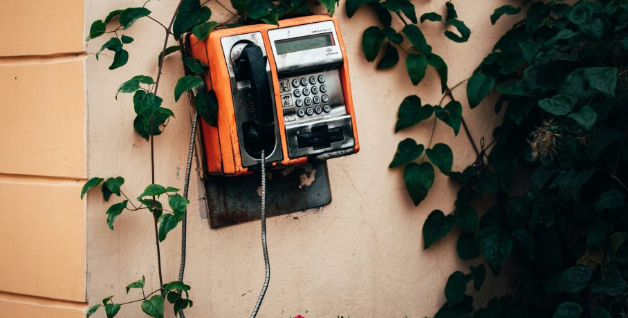 black & orange public telephone