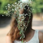 a girl carrying a plants or flower