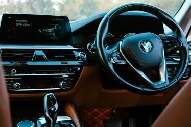 https://unsplash.com/photos/the-interior-of-a-bmw-car-with-a-dashboard-and-steering-wheel-ZLjirtjrjYg?utm_content=creditShareLink&utm_medium=referral&utm_source=unsplash